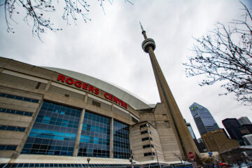 Street view of the Rogers Centre stadium and CN Tower in the background.